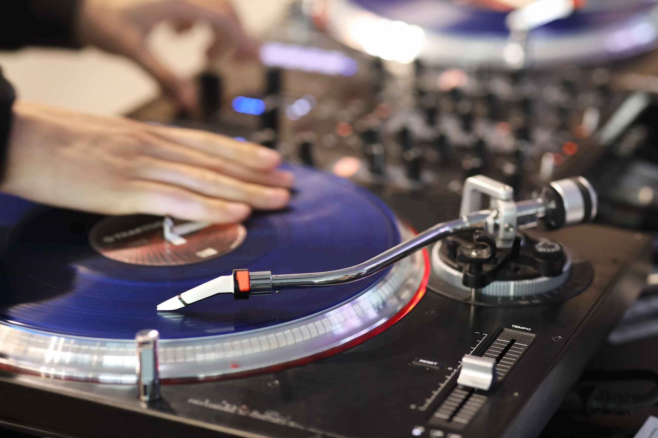 DJ scratching vinyl record on DJ turntable